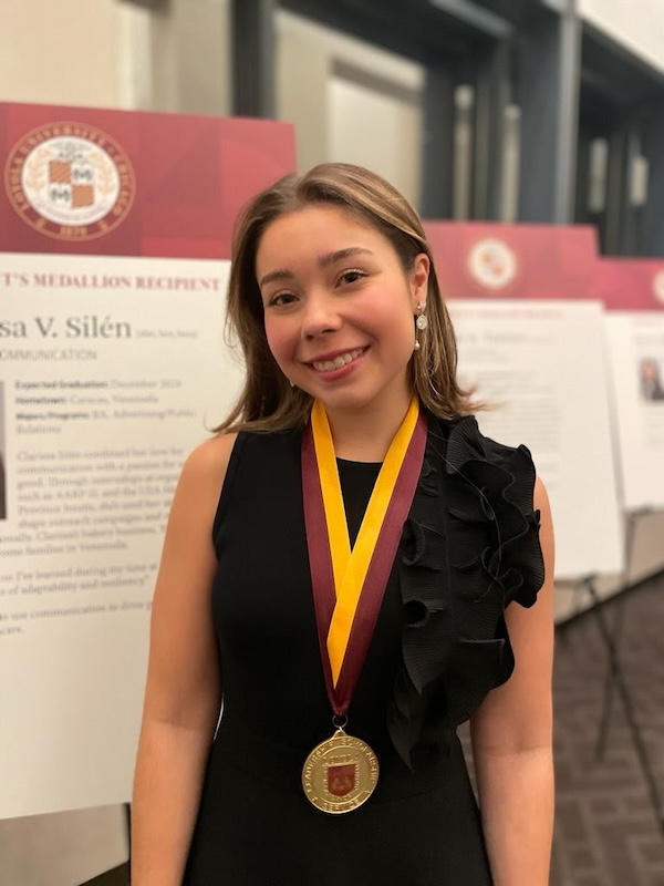 Clarissa Silen, Loyola Chicago's President Medallion Award winning student for the SOC, wearing medallion smiling at award dinner